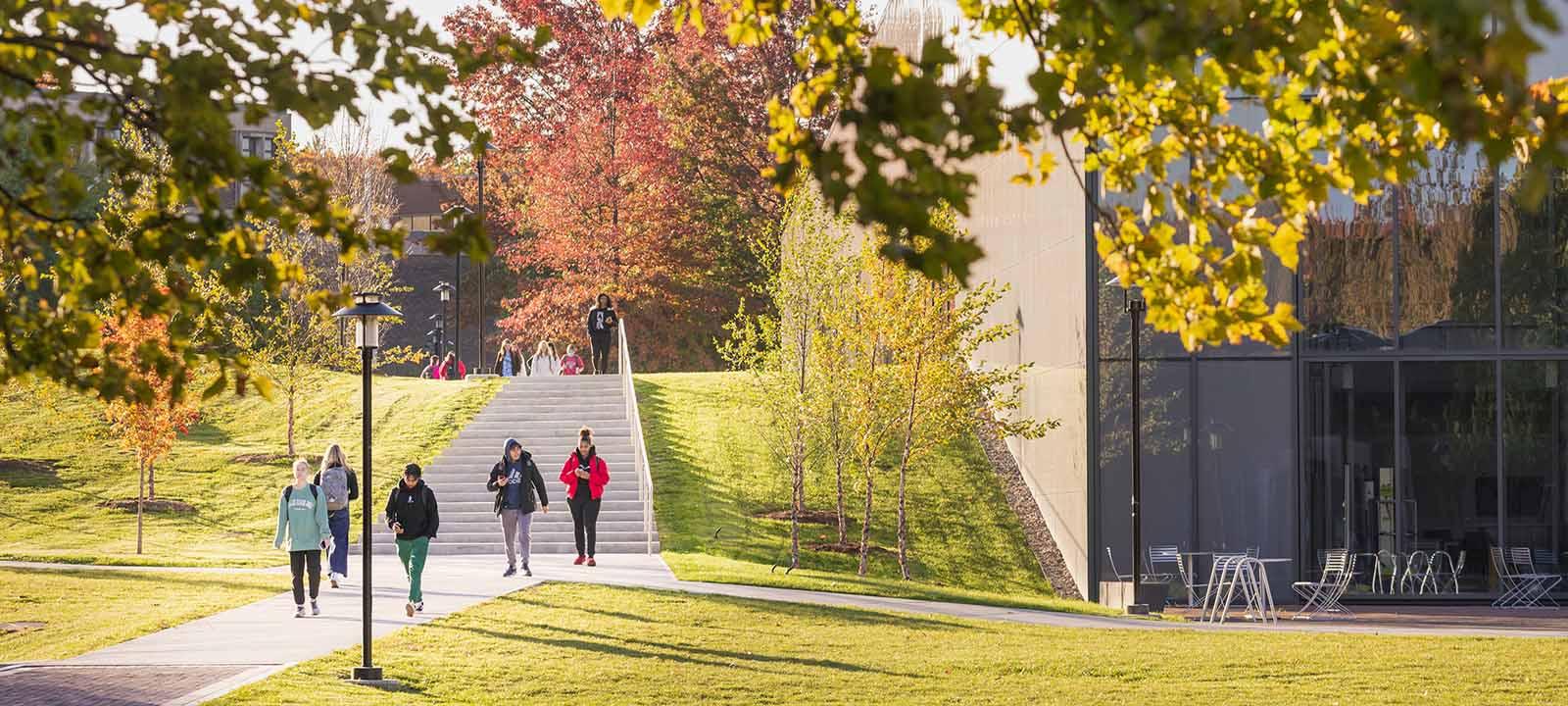Students walking across the campus green.